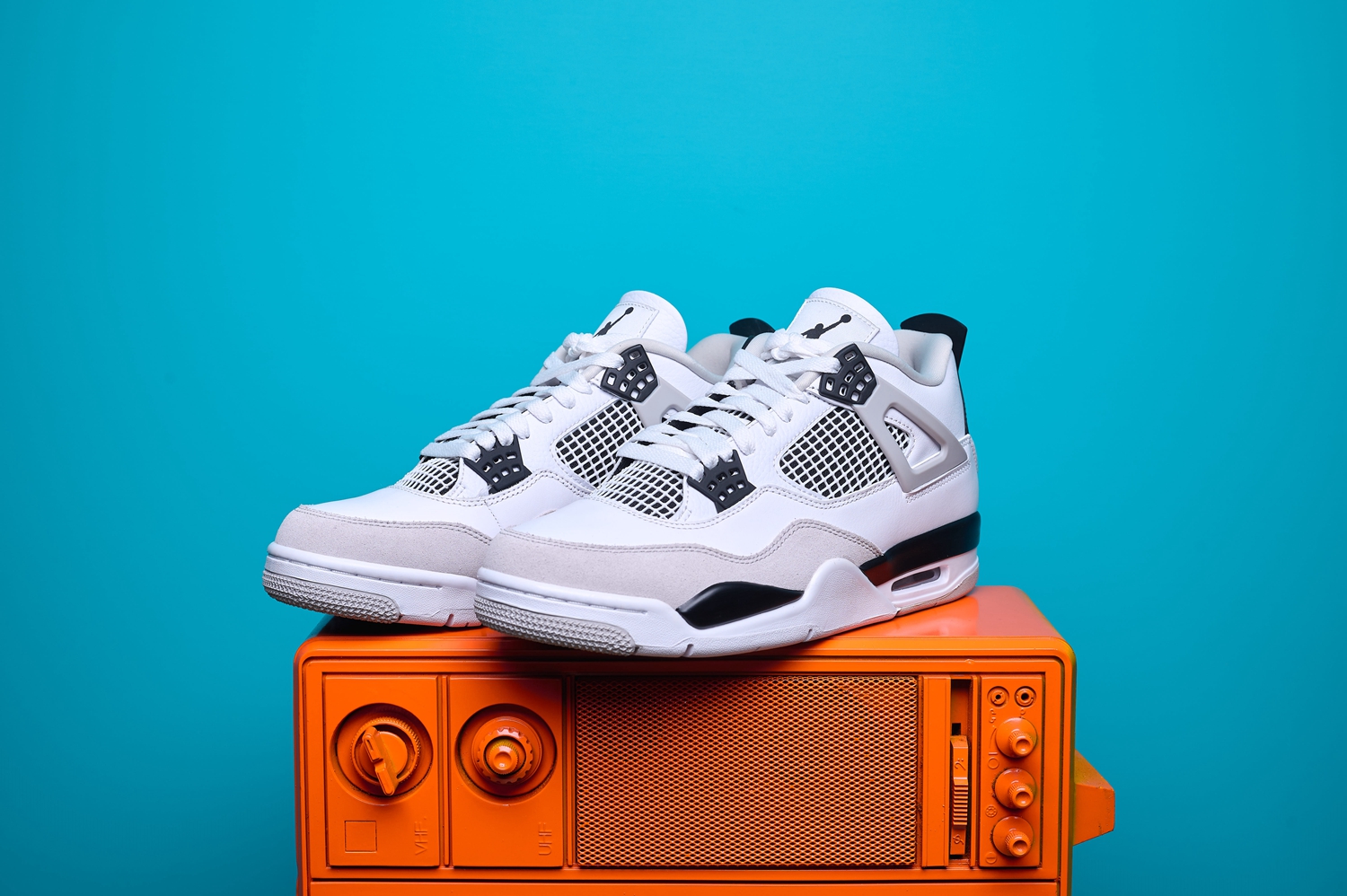 Nike Air Jordan 4, destacando os painéis laterais em mesh, a entressola robusta e os detalhes clássicos do modelo.